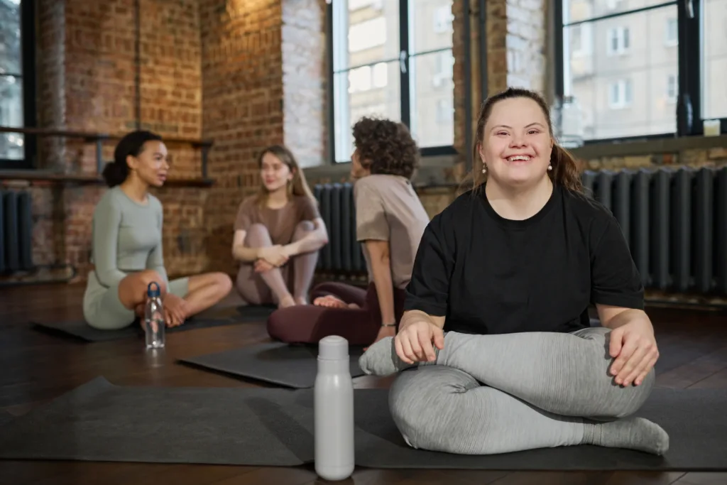 An inclusive yoga class hosted by NDIS Support Services Melbourne, featuring participants of different abilities.