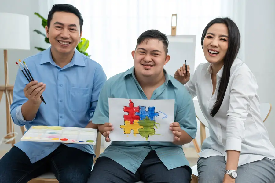 Participants in an NDIS Support Services Melbourne art therapy session proudly display their colorful paintings.