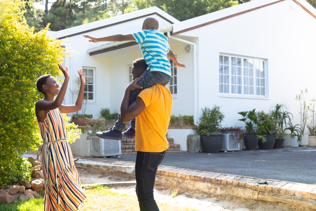 A joyful family scene with a father carrying his child on his shoulders and a mother clapping, showcasing a supportive environment in parenting a child with a disability.